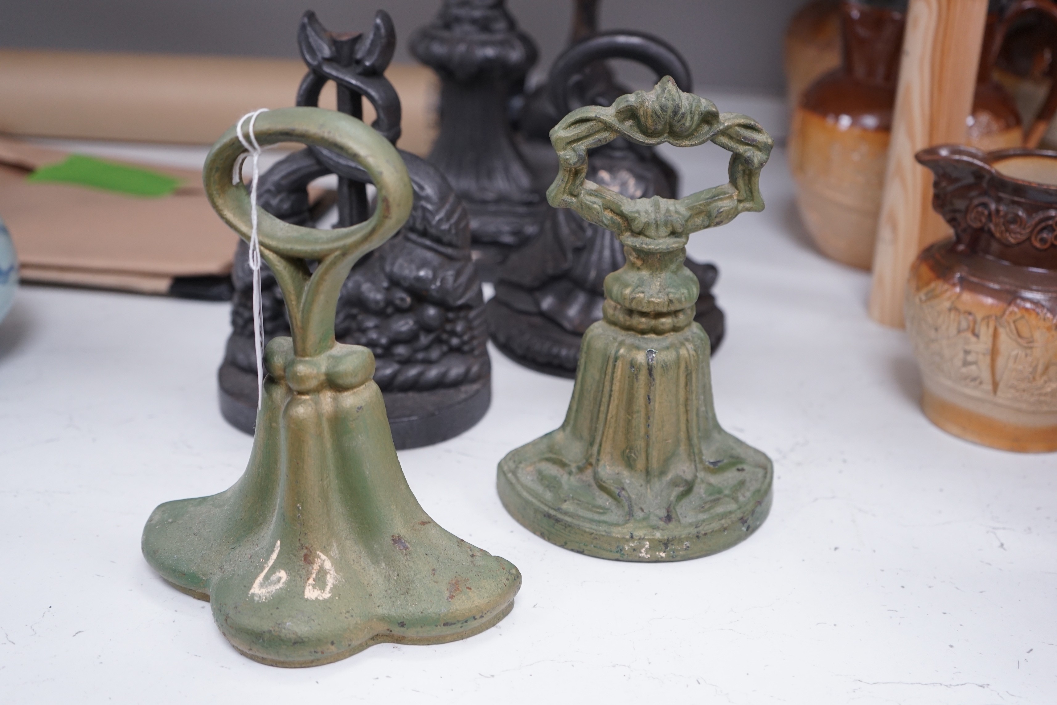 A group of six assorted cast iron Victorian door stops, two later painted, 26cm tall